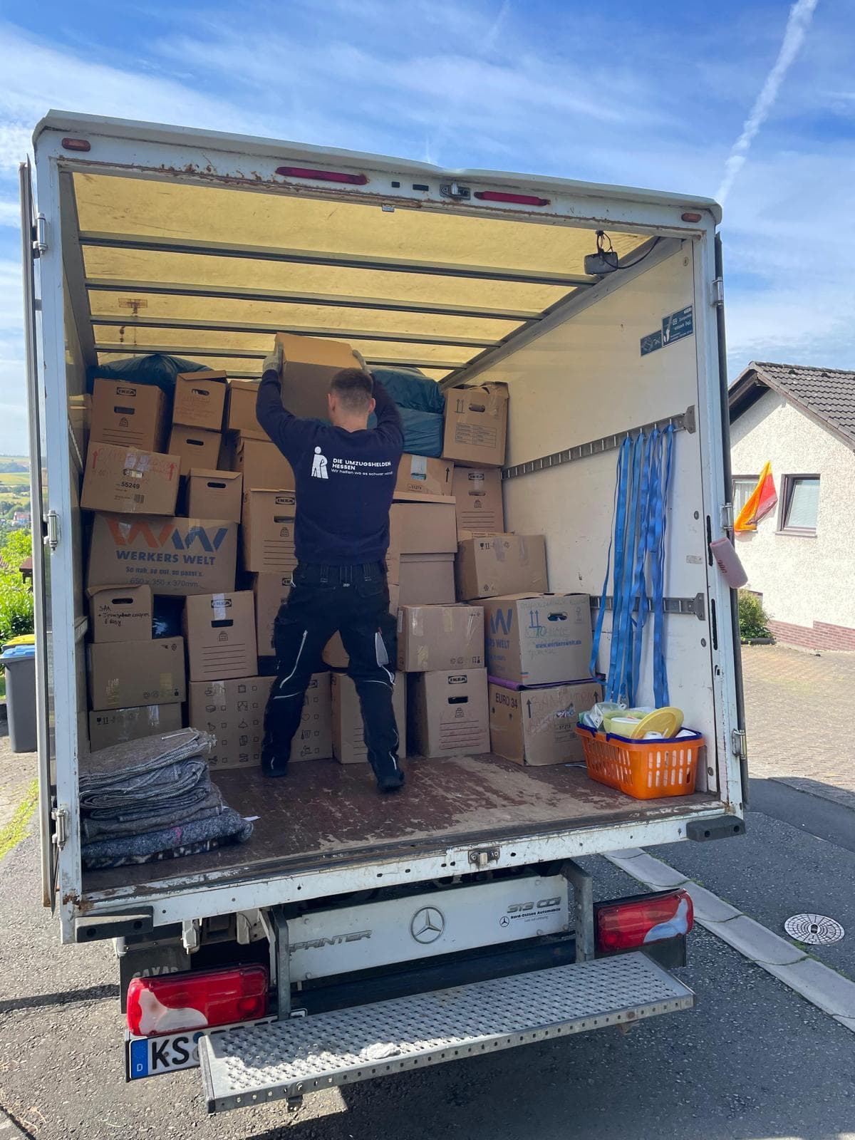 Mitarbeiter der Umzugshelden Hessen belädt den Sprinter mit Umzugskartons in Kassel